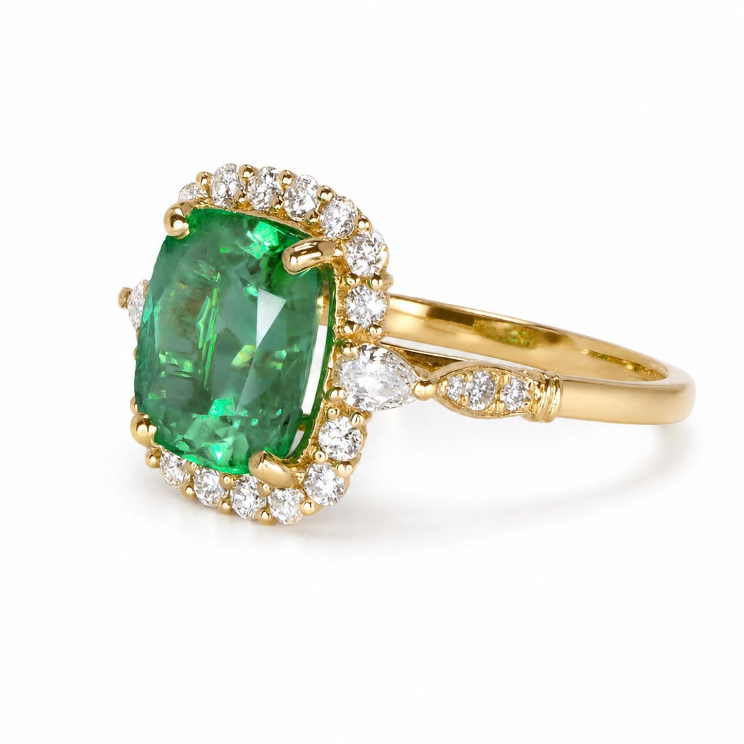 side view of a yellow gold ring featuring a cushion-cut Colombian emerald surrounded by a halo of diamonds, set against a clean white background.