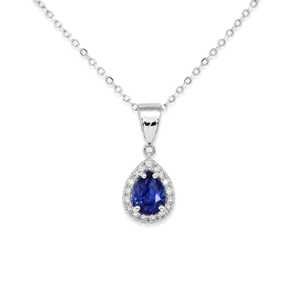 A blue sapphire pendant featuring pear-cut shape surrounded by round brillian-cut diamonds set in 18K white gold and shown on a white background 