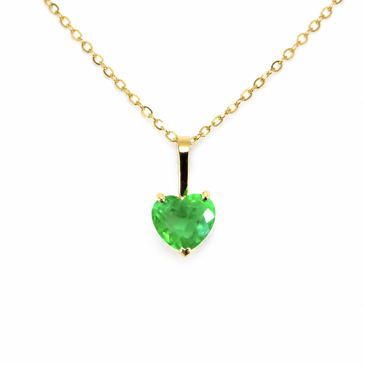 A yellow gold necklace with a heart-shaped Colombian emerald, shown against a plain white background.