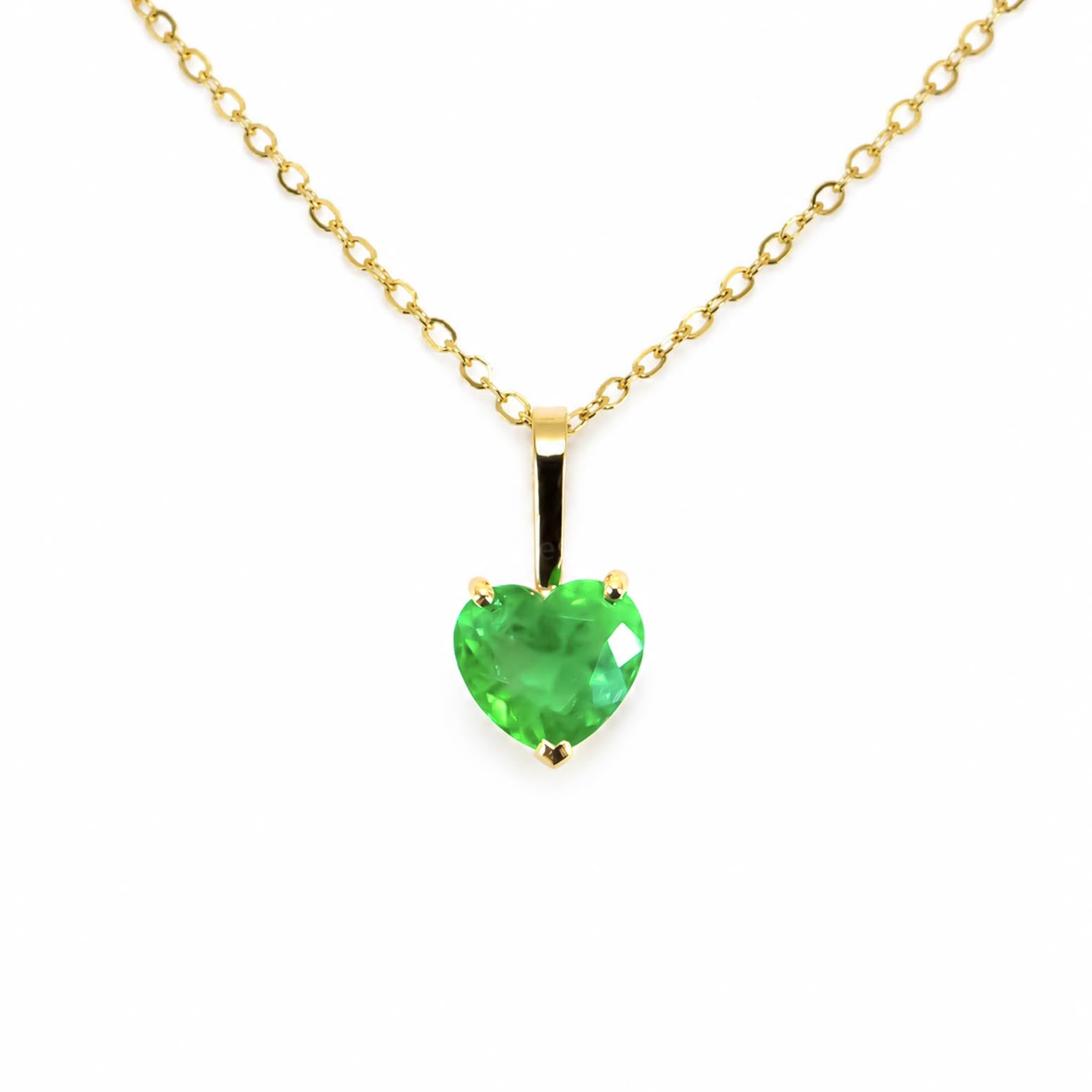 A yellow gold necklace with a heart-shaped Colombian emerald, shown against a plain white background.