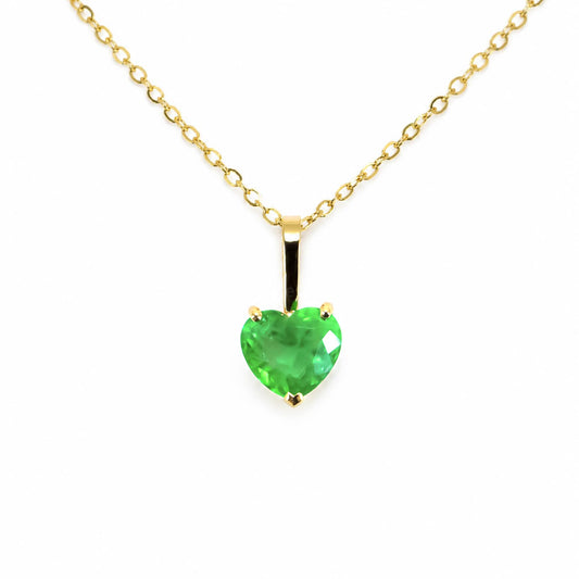 A yellow gold necklace with a heart-shaped Colombian emerald, shown against a plain white background.