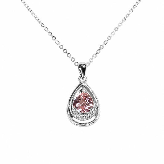 A platinum teardrop pendant necklace featuring a central padparadscha sapphire gemstone accented by a row of diamonds at the bottom of the pendant, suspended from a delicate silver chain on a white background.