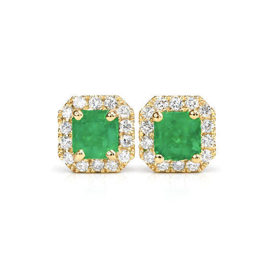 A pair of yellow gold stud earrings featuring emerald-cut Colombian emerald center stones surrounded by a halo of small pavé-set diamonds, shown on a plain white background.