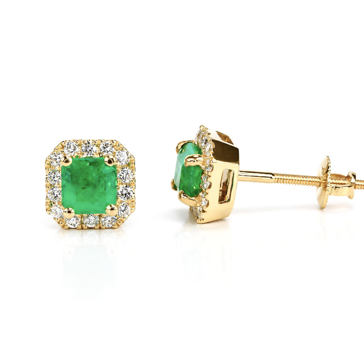 A pair of gold stud earrings featuring emerald-cut Colombian emeralds surrounded by a halo of small diamonds, shown on a clean white background with one earring facing forward and the other angled to show the post and back.