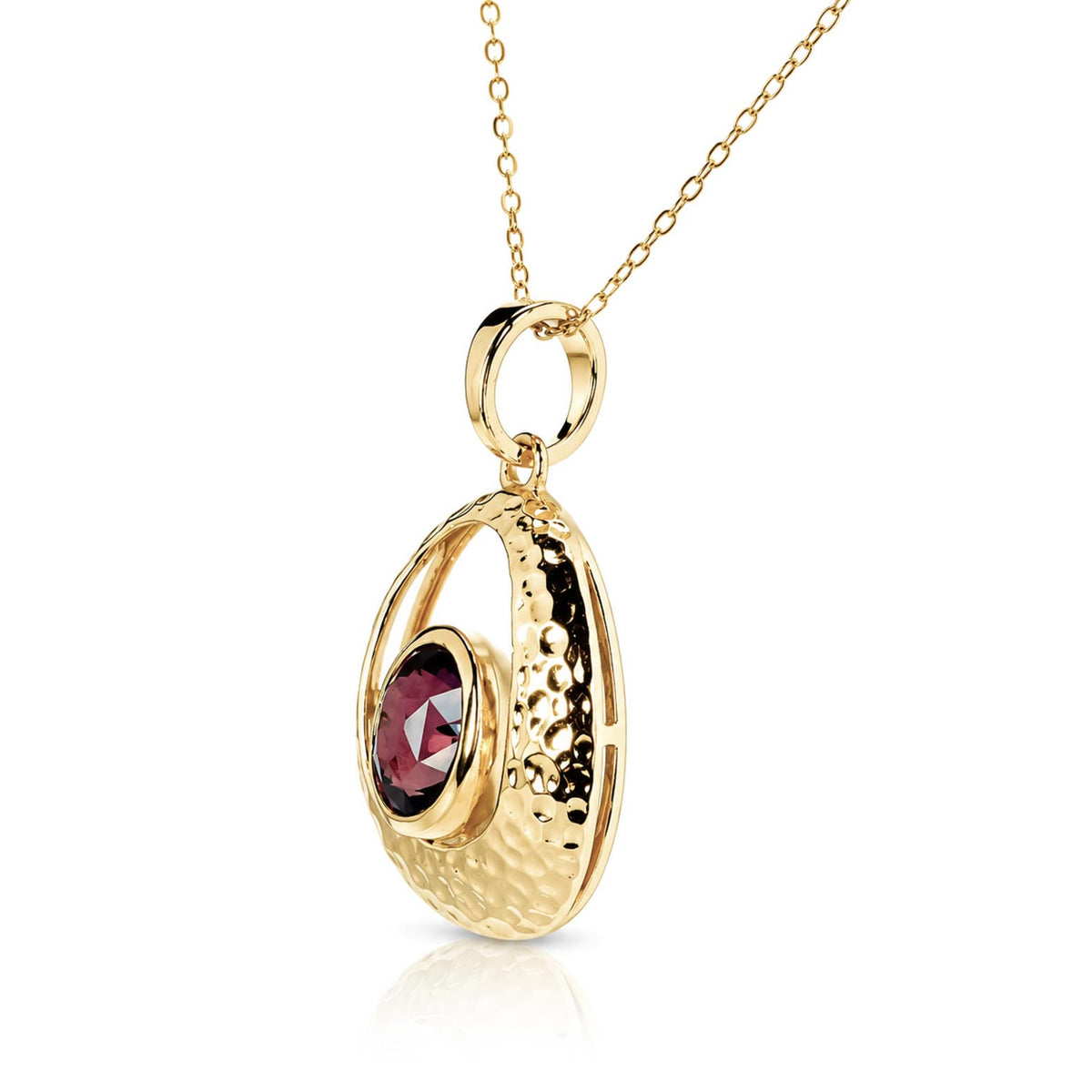 A gold pendant necklace featuring a textured, crescent-shaped gold frame with a faceted dark red sapphire at its center, suspended from a delicate gold chain on a white background.