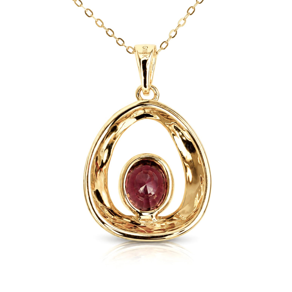 Back view of a gold pendant necklace featuring an open, textured oval design with a central round red-brown sapphire gemstone, shown on a white background with a soft reflection.