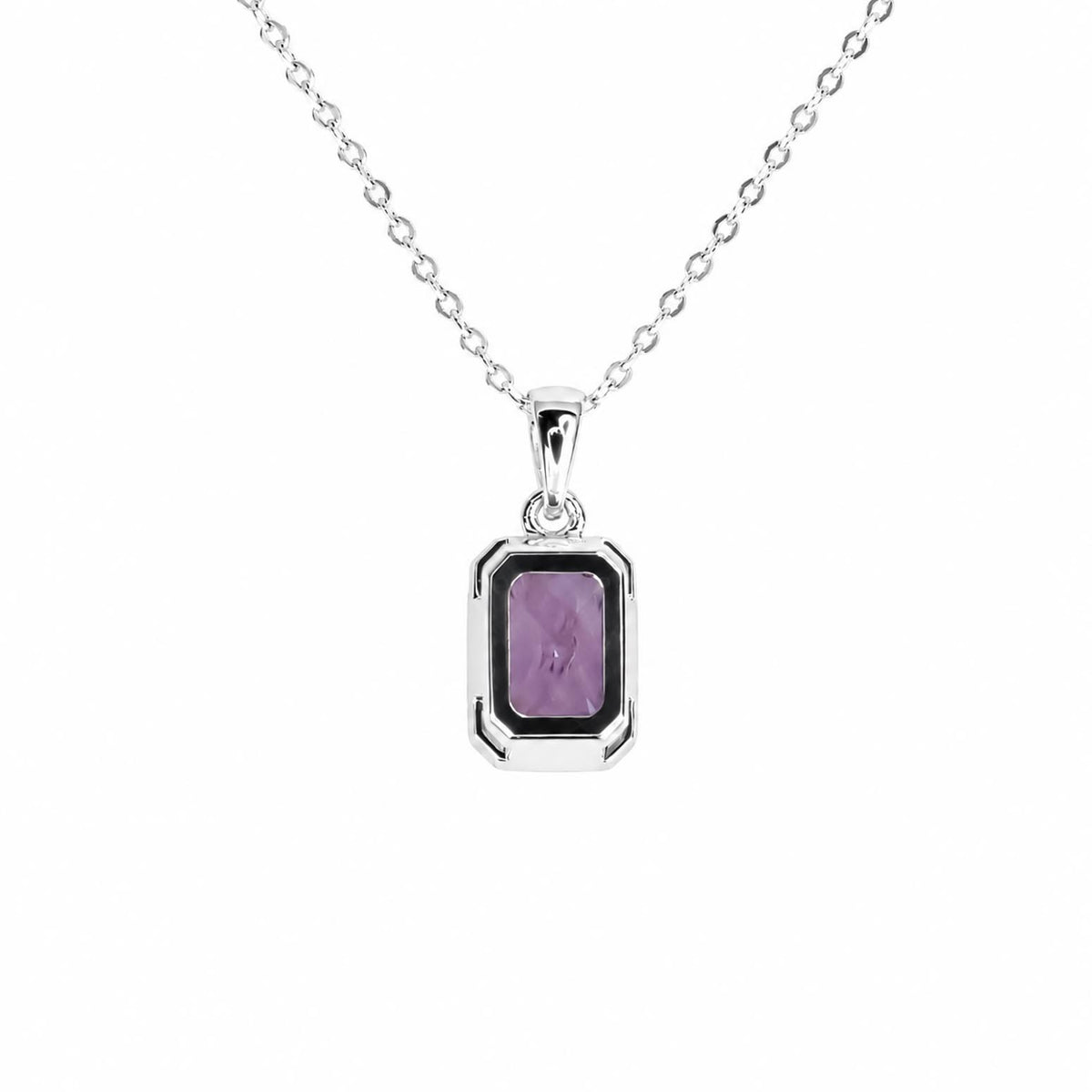 A back view of a platinum necklace with a rectangular bezel setting featuring a faceted purple sapphire, set against a plain white background.