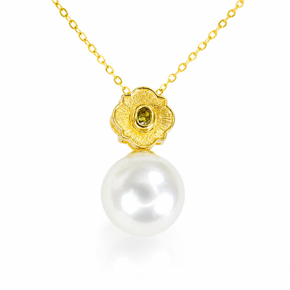 A gold pendant necklace featuring a textured flower-shaped setting with a small oval alexandrite and a large, lustrous white pearl hanging below, shown on a clean white background.