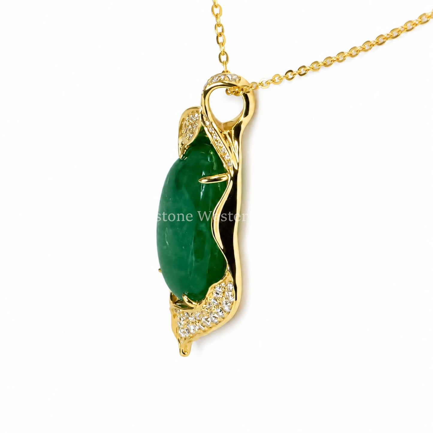 A yellow gold pendant that holds an elongated cabochon Colombian emerald set in prongs in a freeform gold pendant on a white background 