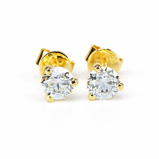 A pair of diamond stud earrings set in yellow gold on a white background 
