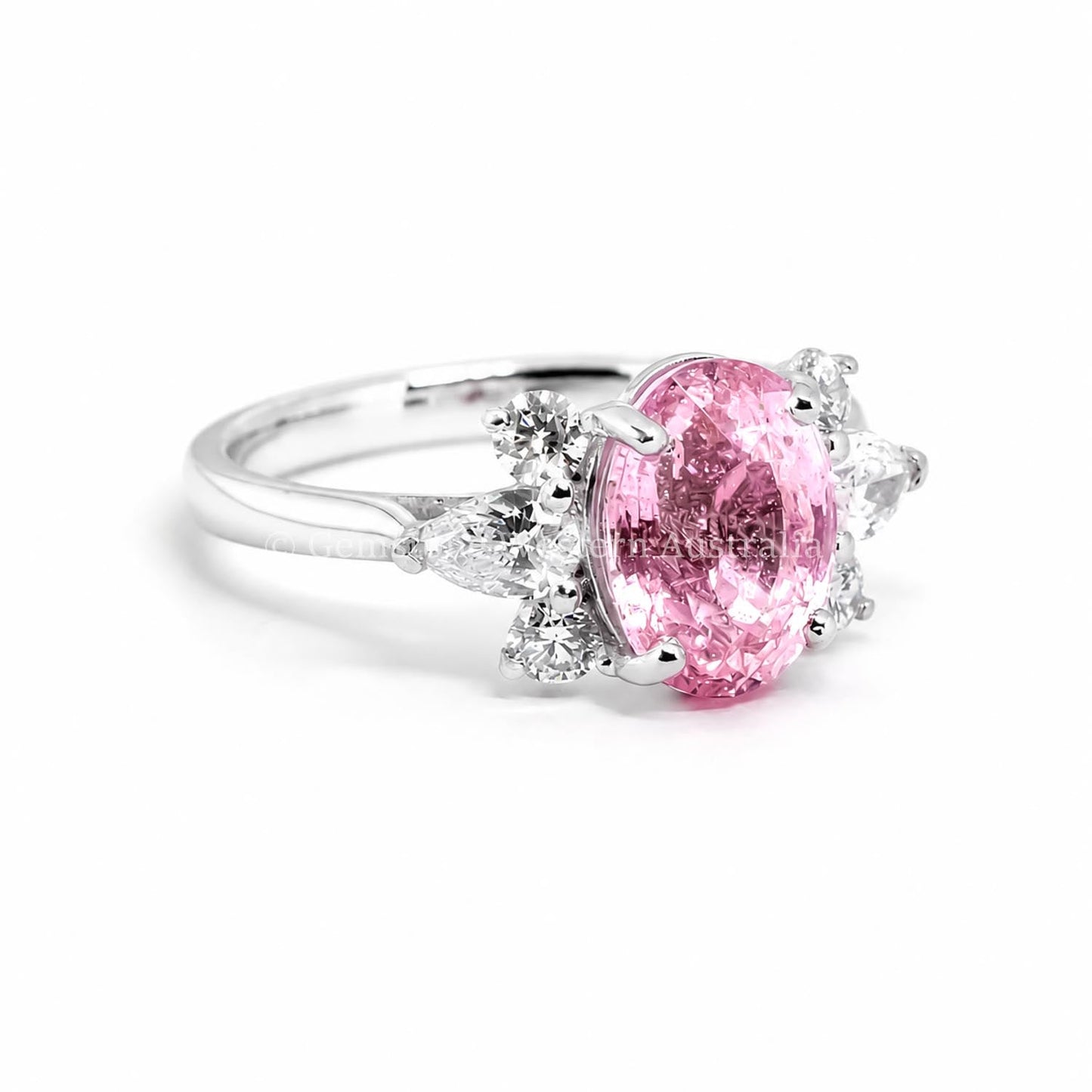 Natural unheated oval-cut padparadscha sapphire ring with pear and round brilliant diamonds