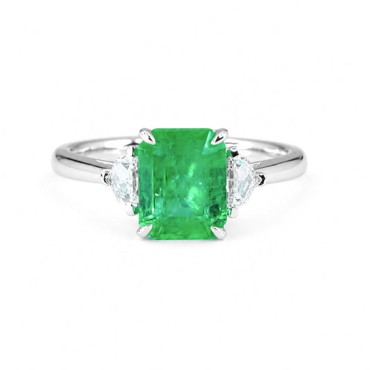 2.21 carat natural Colombian emerald cut three stone ring in 18K white gold