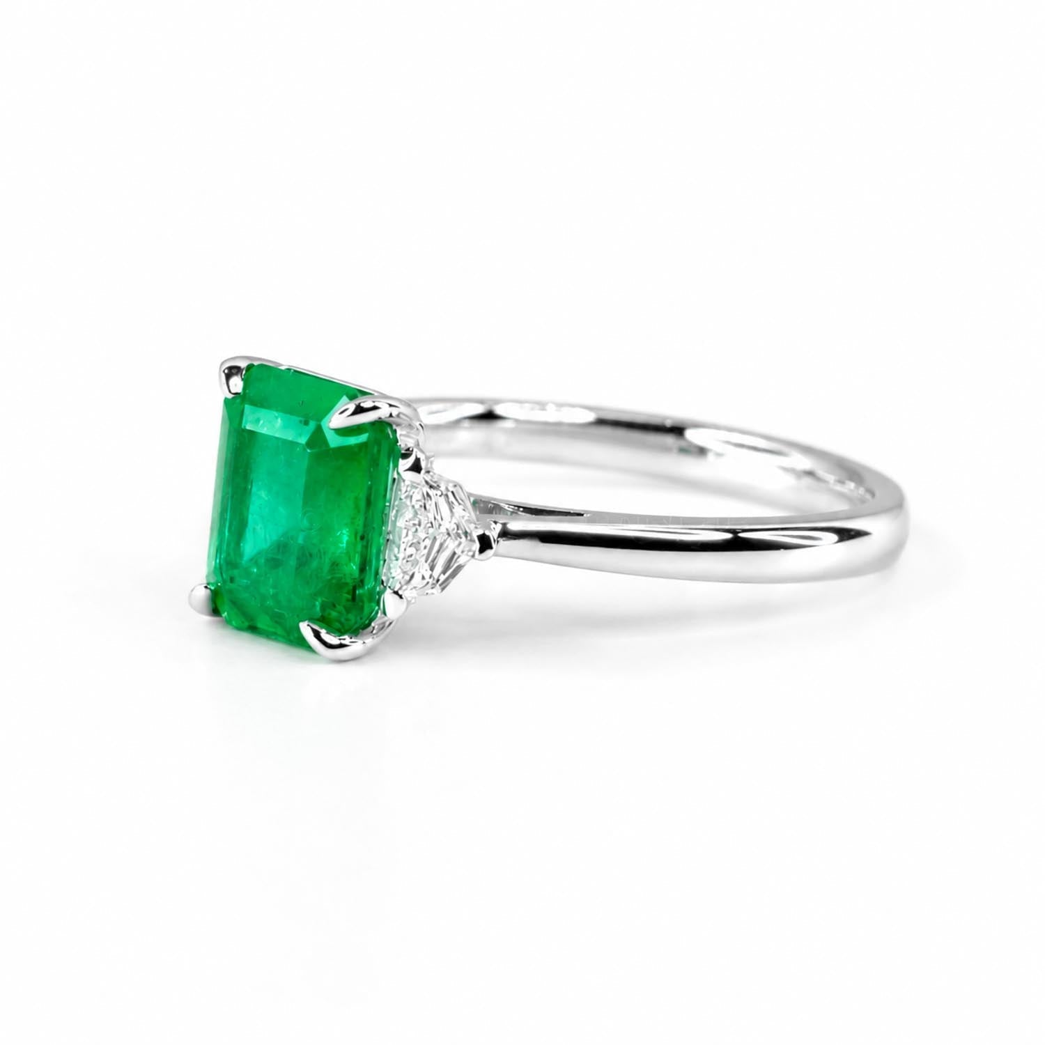 Colombian emerald ring with Cadillac cut diamond accents in 18K white gold