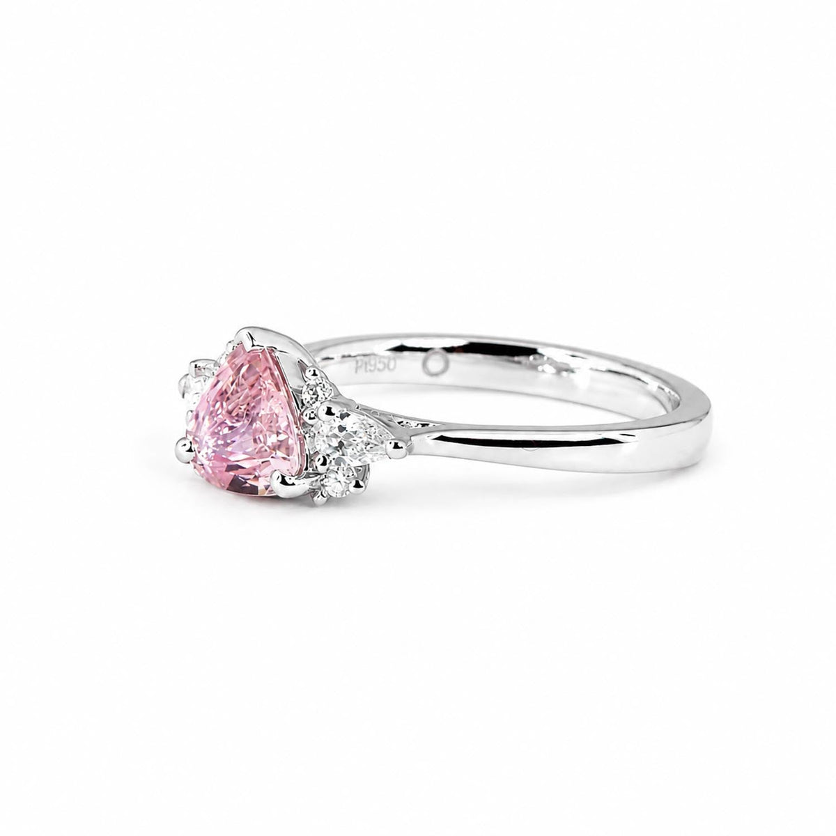 Pear cut pink sapphire ring in platinum with diamond side stones