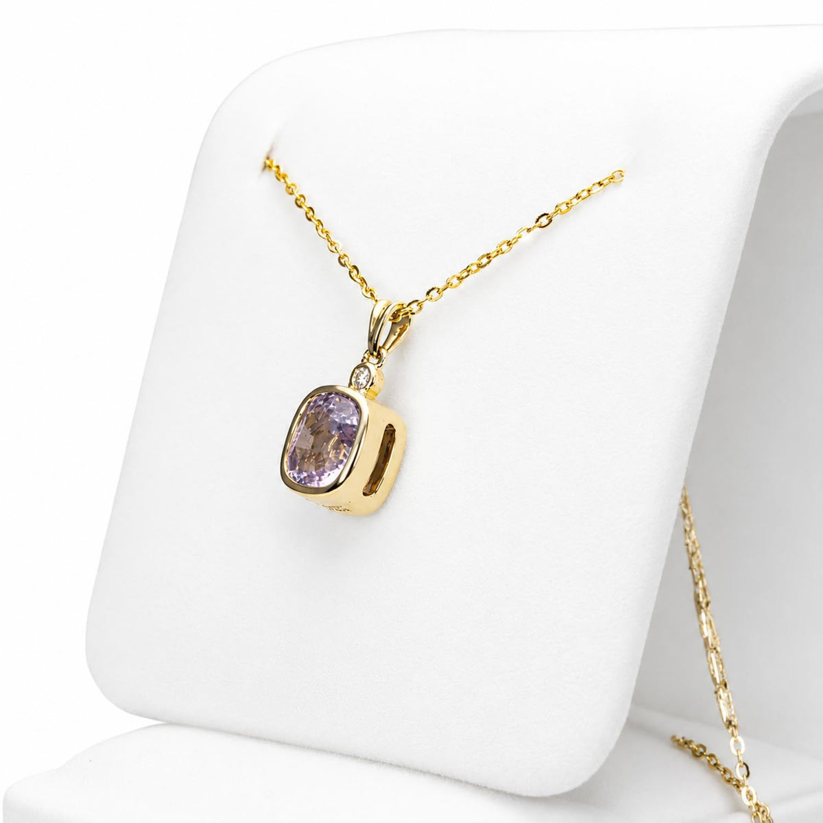 Close view of the 2.58ct cushion cut pink sapphire and diamond pendant in 18K yellow gold