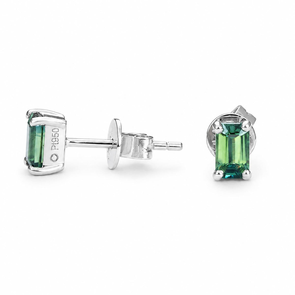 Emerald cut Australian teal sapphire studs in platinum shown at an angle
