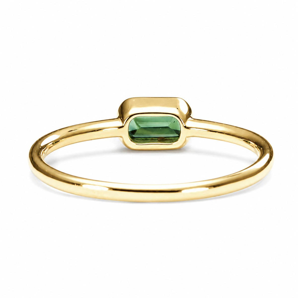 back view of a Yellow gold ring holding an Australian teal sapphire in emerald cut shape that is bezel set, shown on a white background