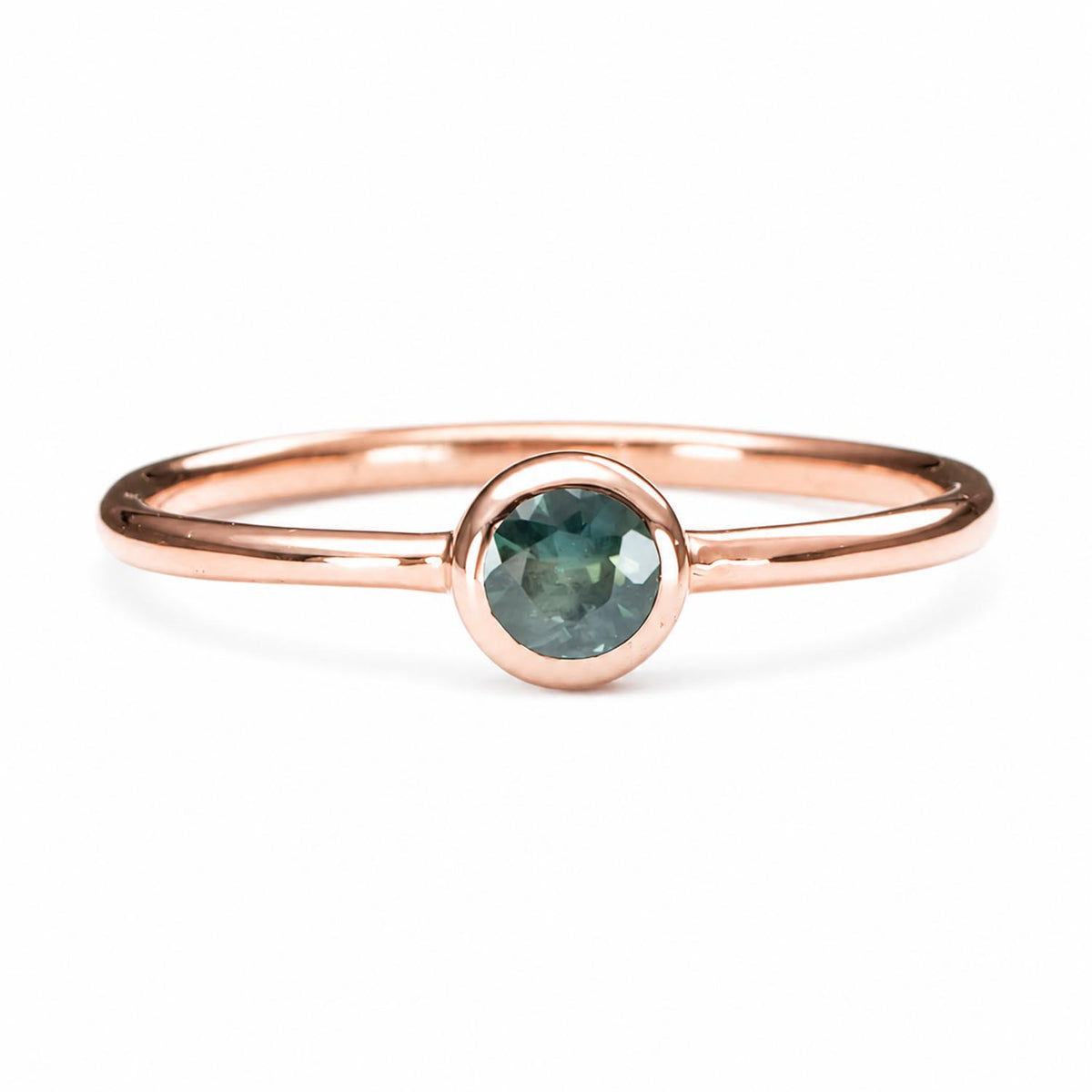 Australian sapphire rose gold ring shown on a white background
