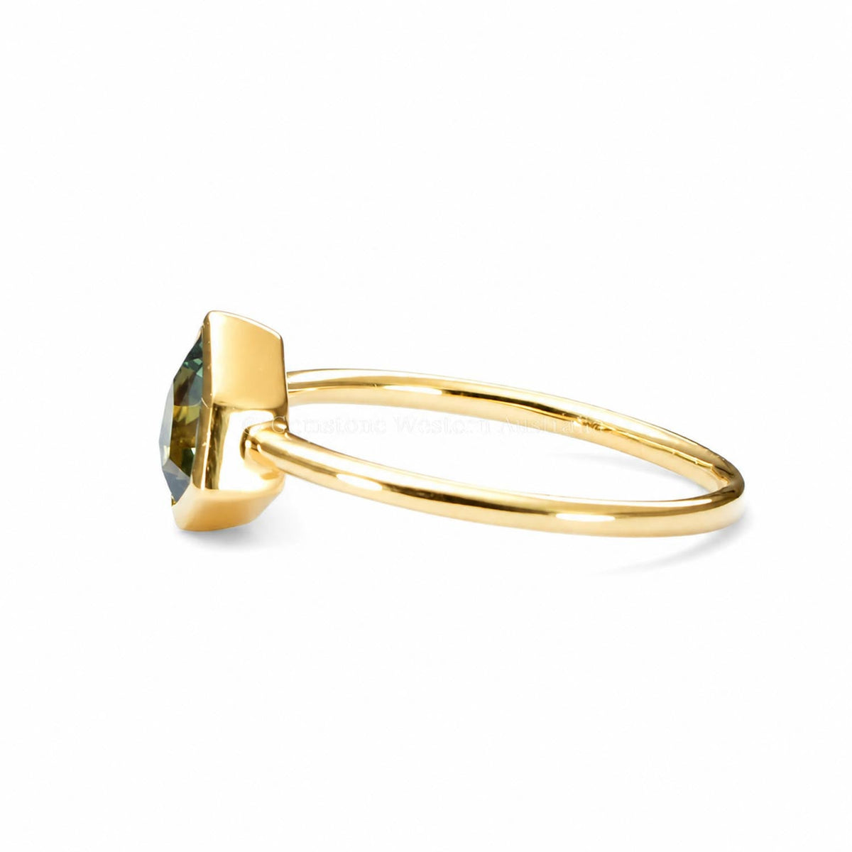 Shield cut teal sapphire ring in 18K yellow gold shown at an angle