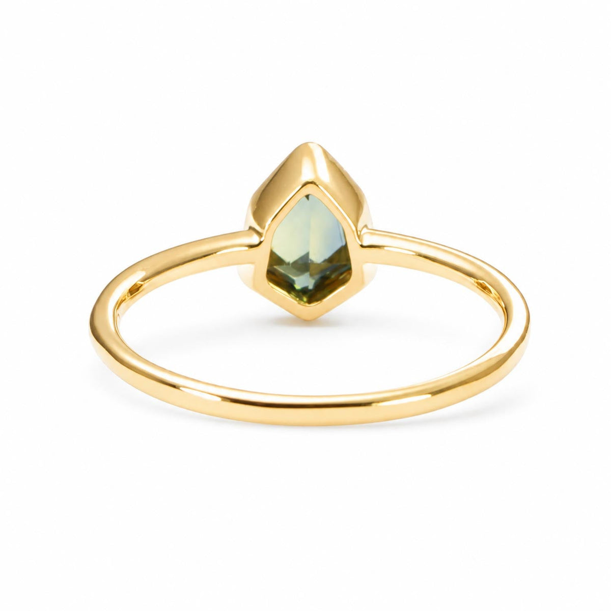 Close detail of the 0.71ct shield cut teal sapphire in 18K yellow gold