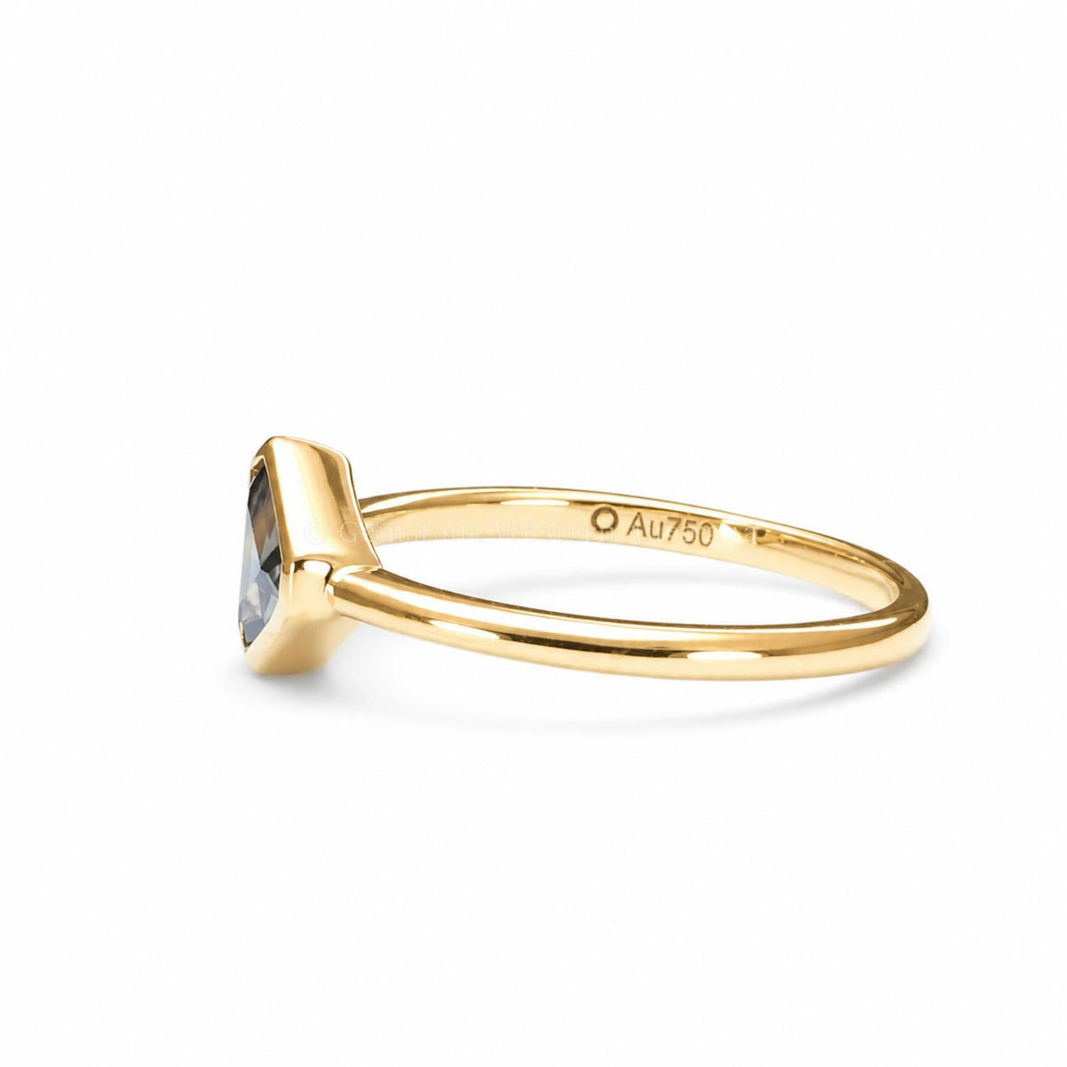Side view of the asymmetrical sapphire and diamond ring in 18K yellow gold
