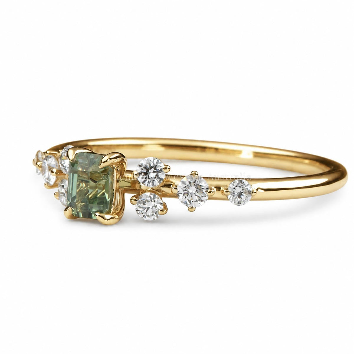 Emerald cut alexandrite and diamond ring in 18K yellow gold shown at an angle
