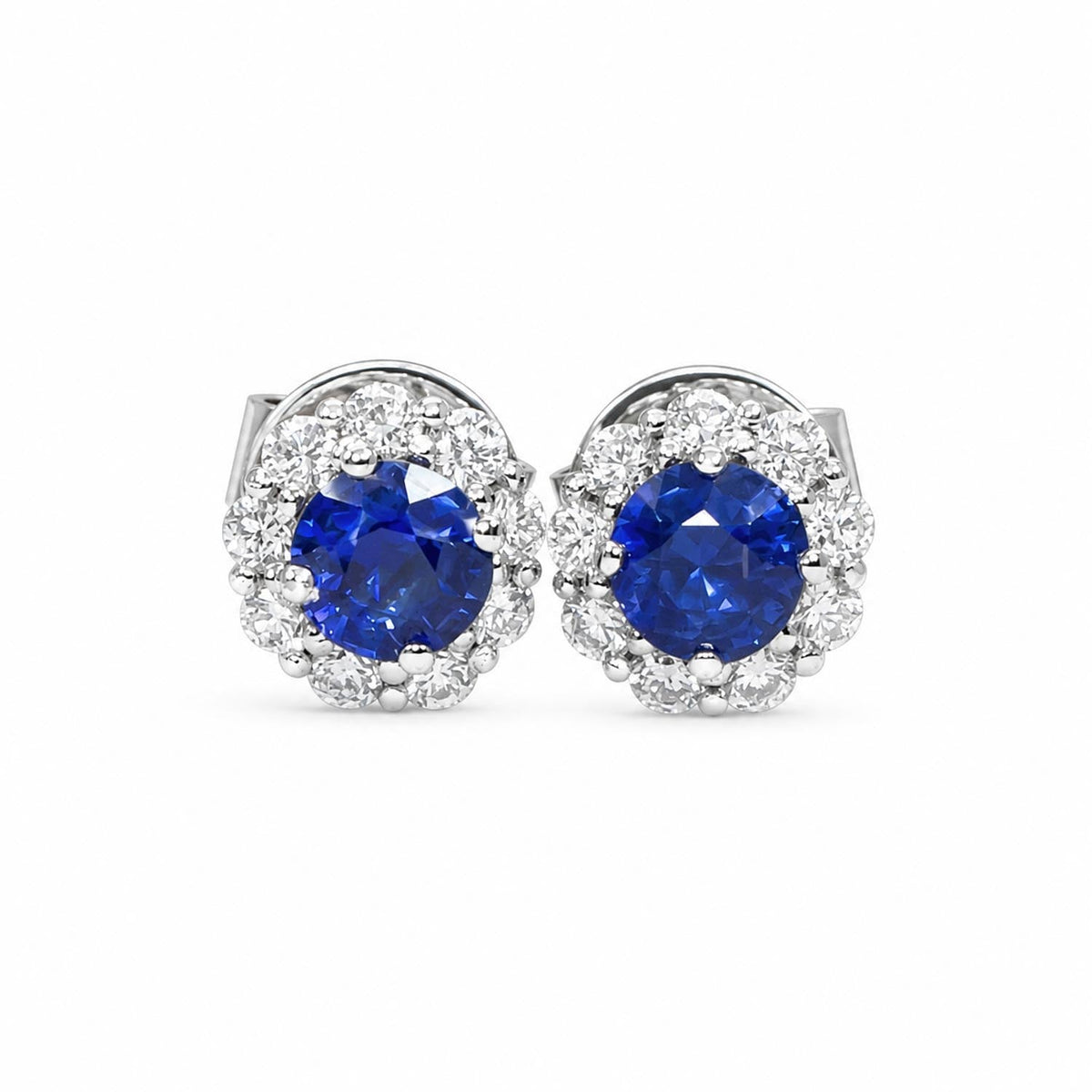 Natural blue sapphire stud earrings with a diamond halo in 18K yellow gold