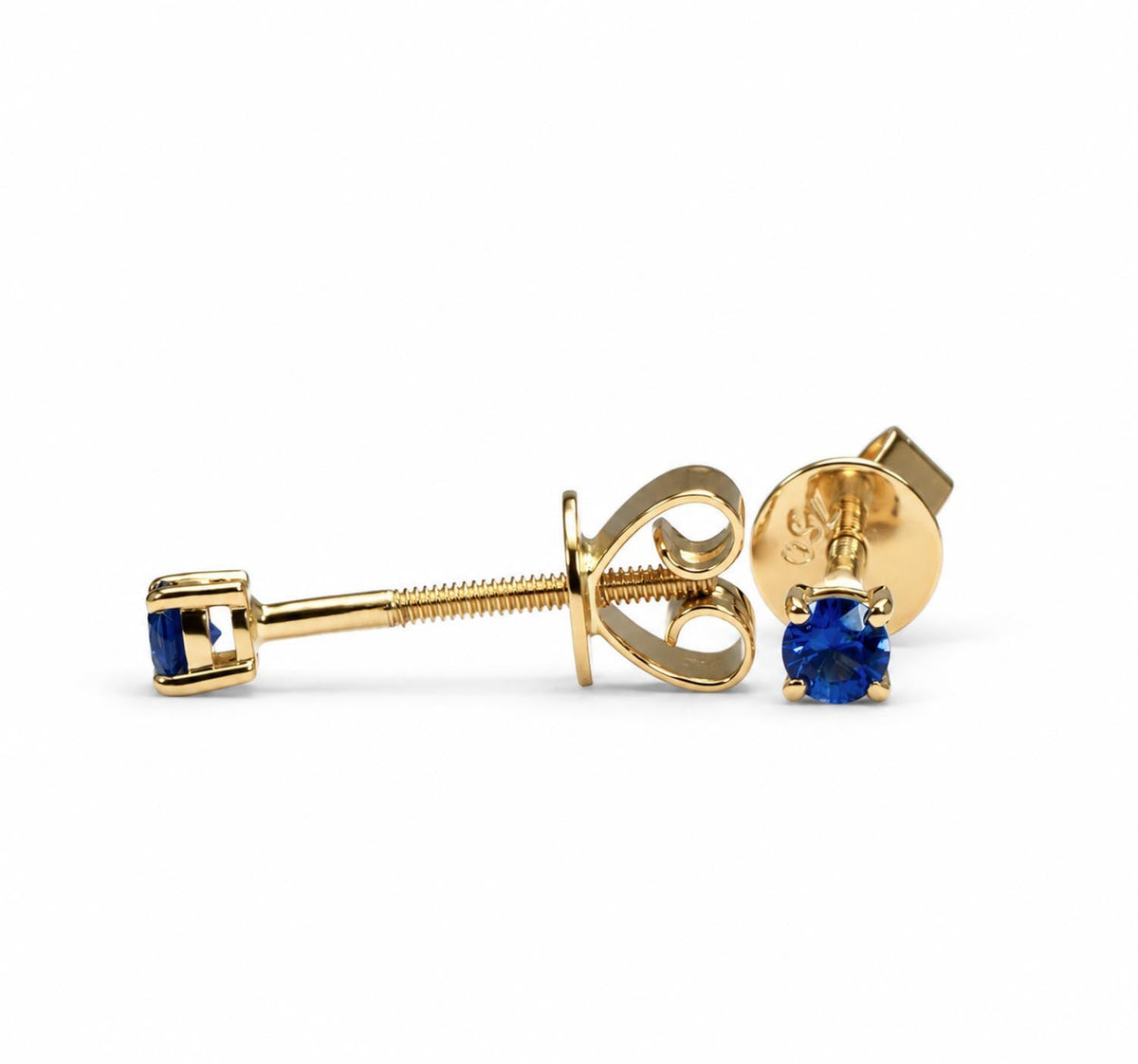 Petite blue sapphire studs in 18K yellow gold shown at an angle