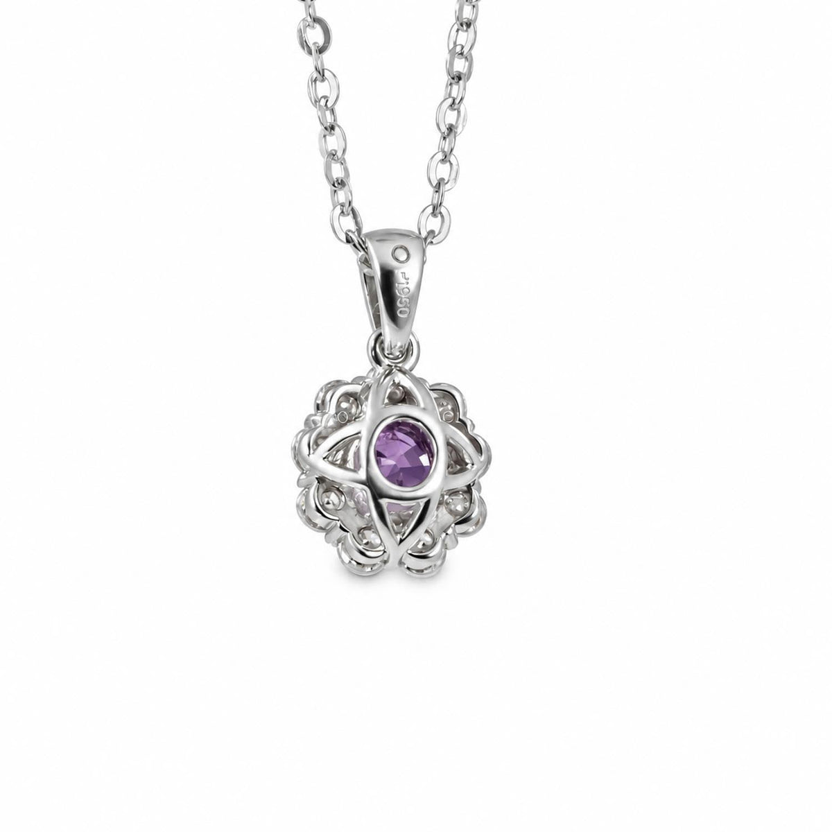 Close detail of the natural pink sapphire and moissanite halo in platinum