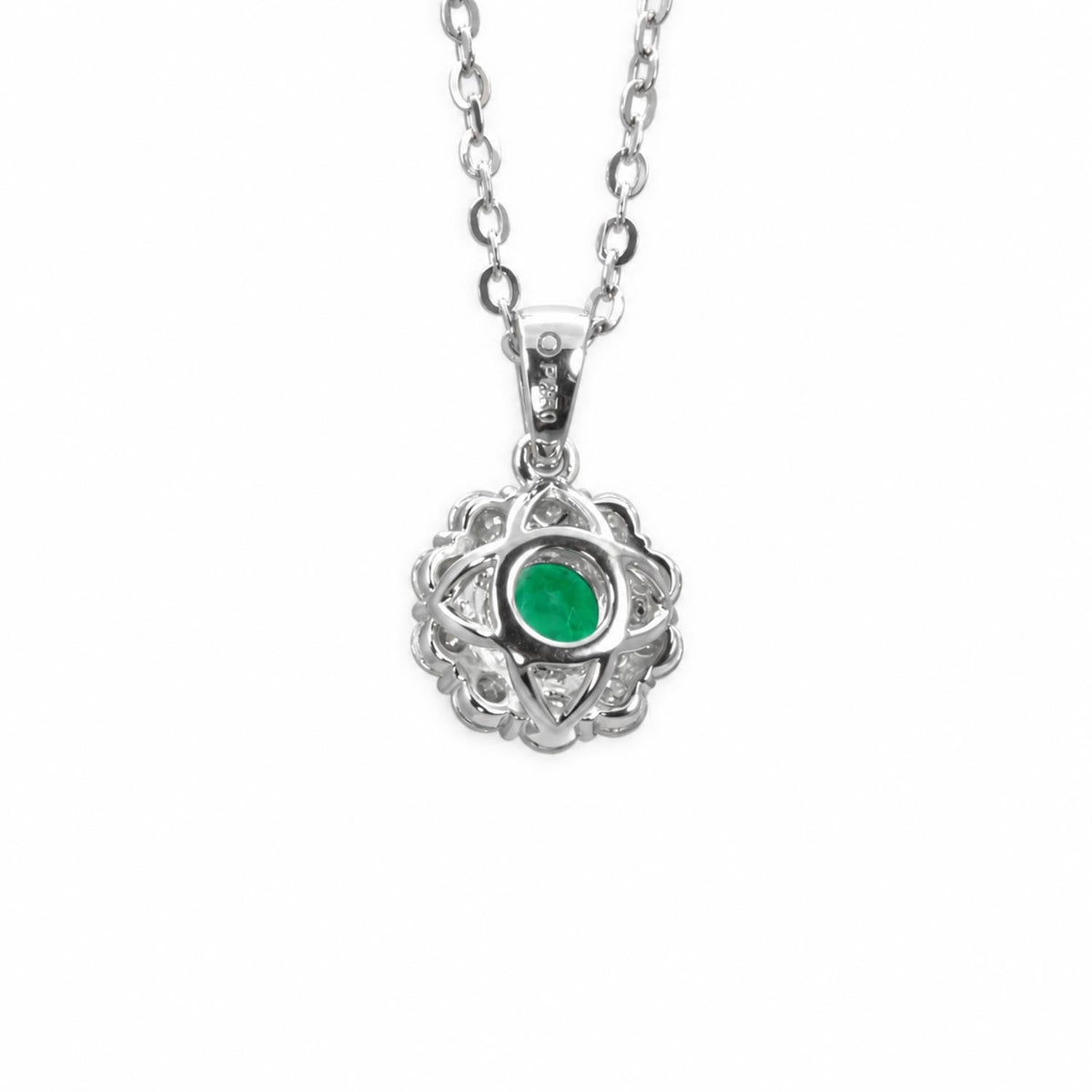 Colombian emerald moissanite halo pendant in platinum 950 shown at an angle