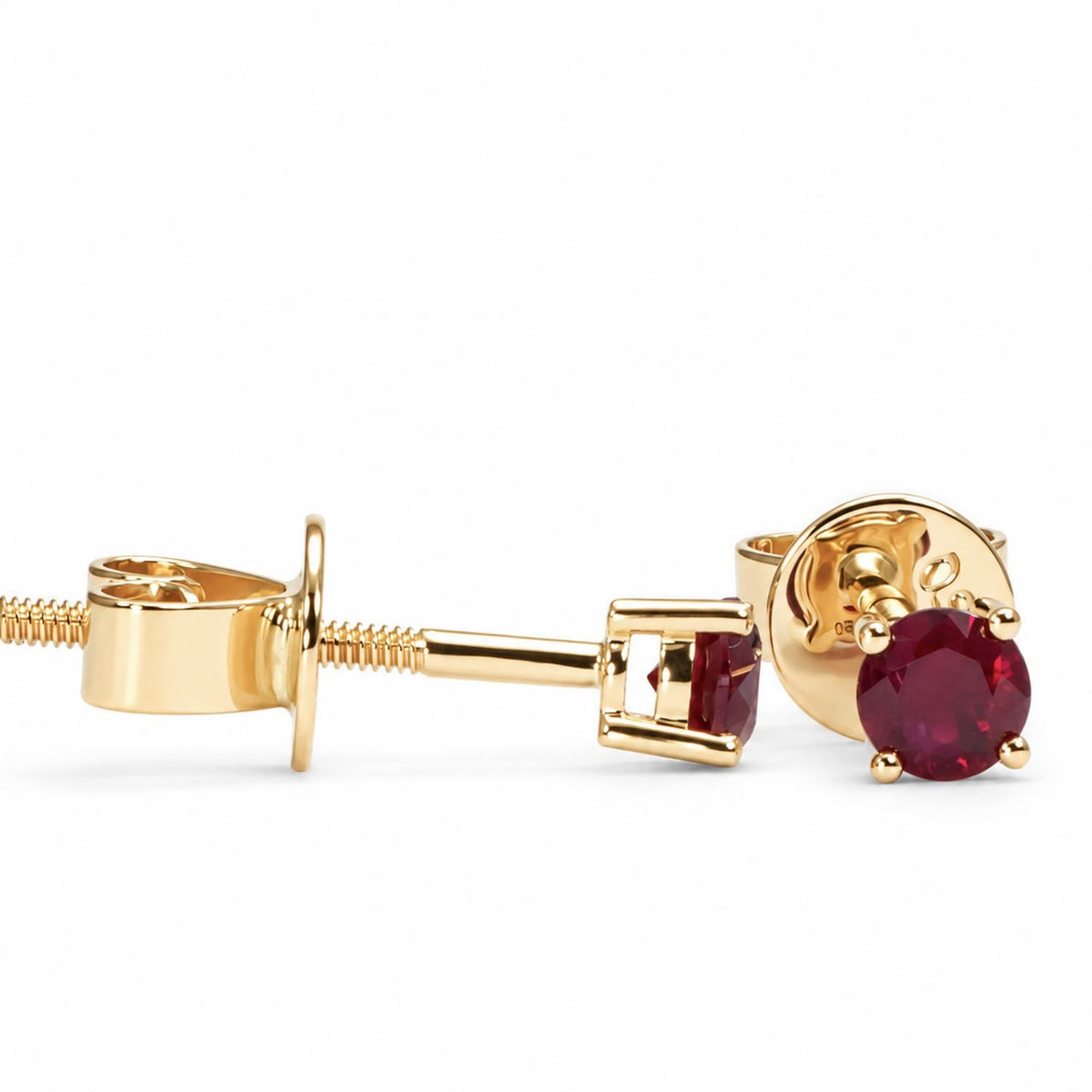 0.35ct natural ruby studs in 18K yellow gold shown at an angle