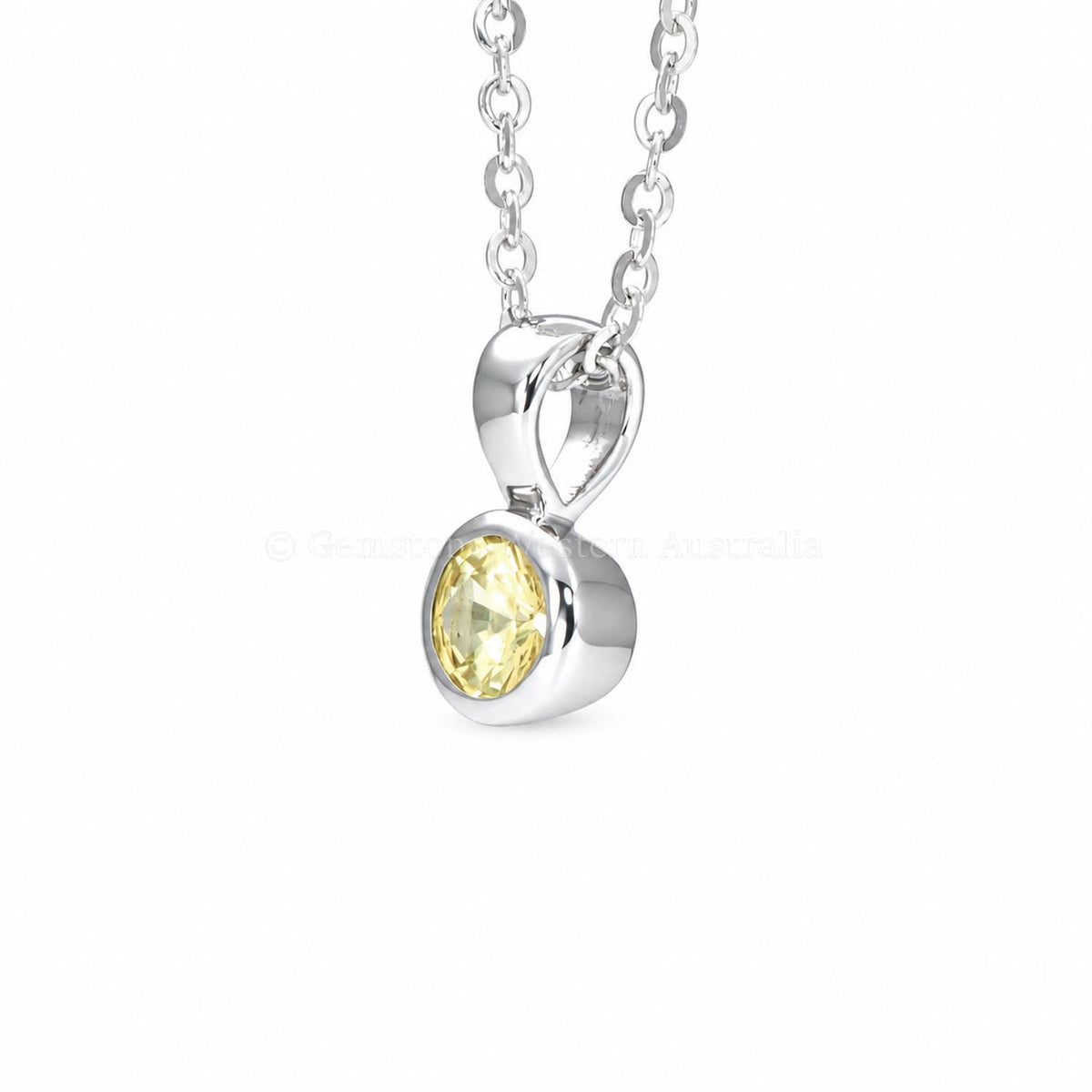 Unheated yellow sapphire pendant in platinum 950 shown at an angle