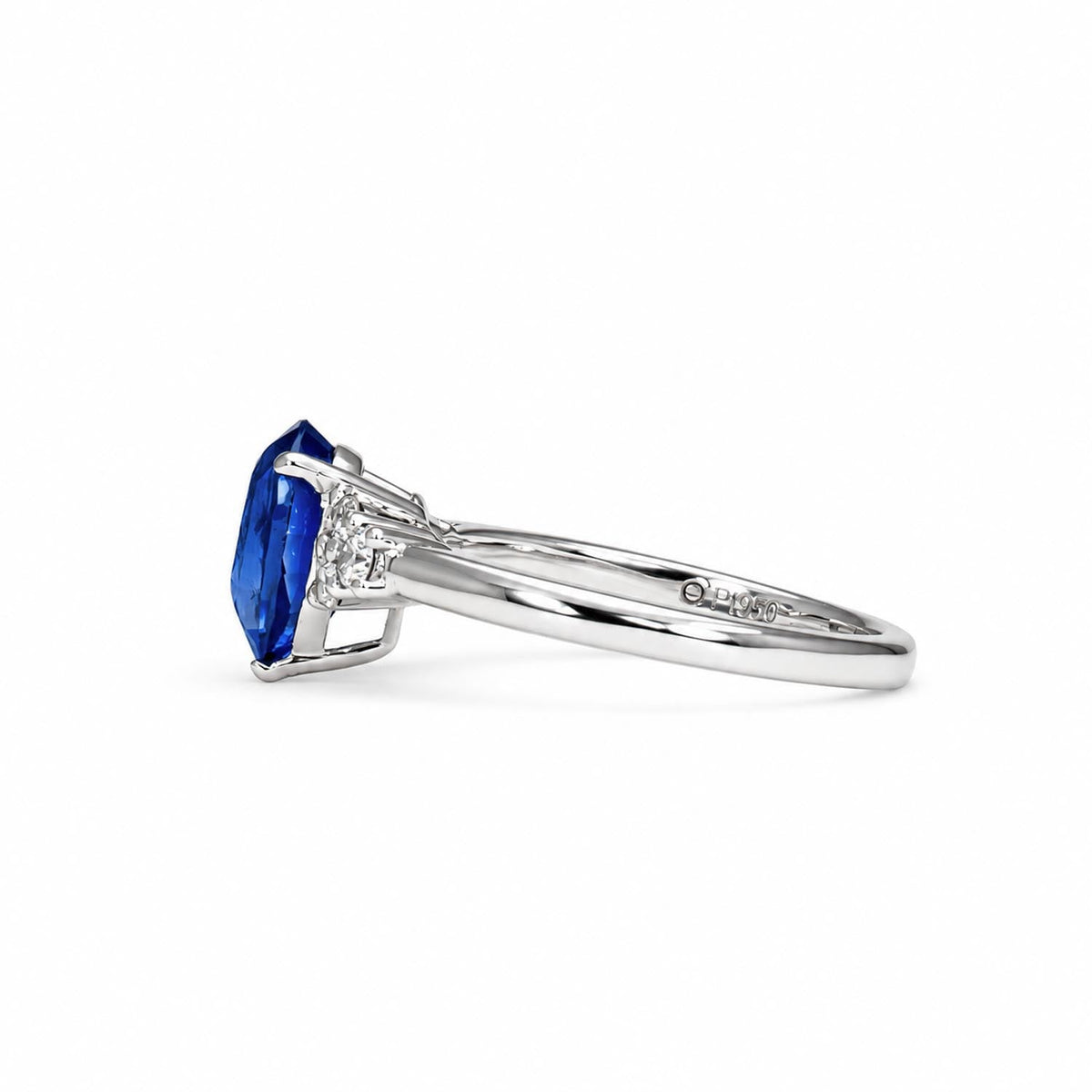 Royal blue sapphire and diamond platinum ring shown at an angle
