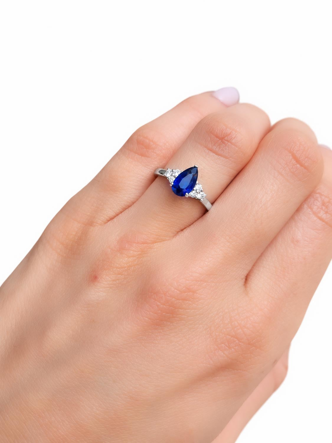 Side profile of the pear shaped royal blue sapphire ring in platinum
