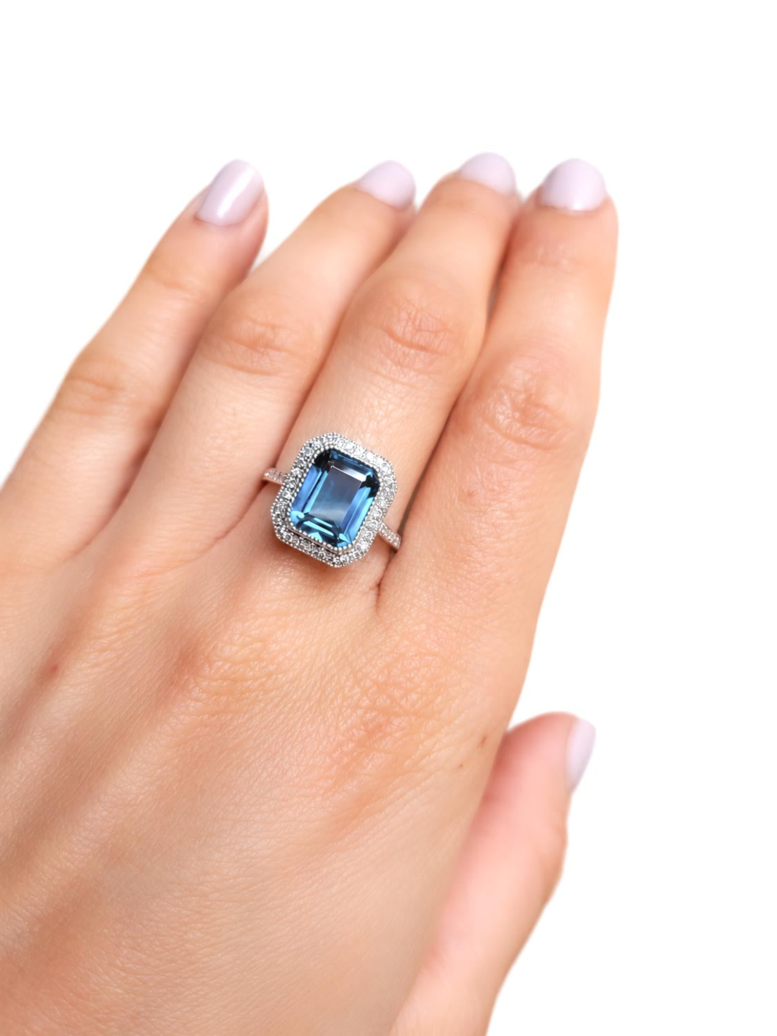 Close detail of the emerald cut London blue topaz in 18K white gold
