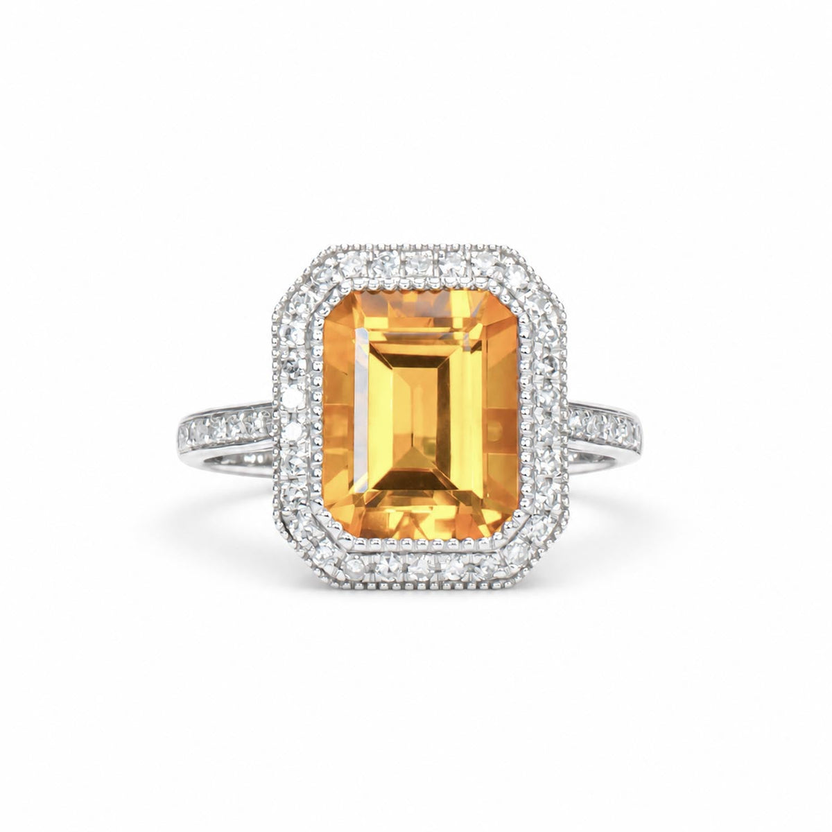 Emerald cut citrine ring with a diamond halo in 18K white gold