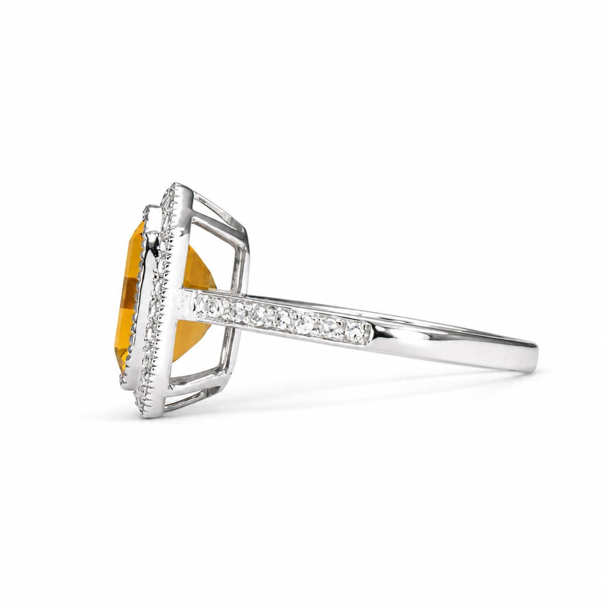 Citrine and diamond halo ring in 18K white gold shown at an angle