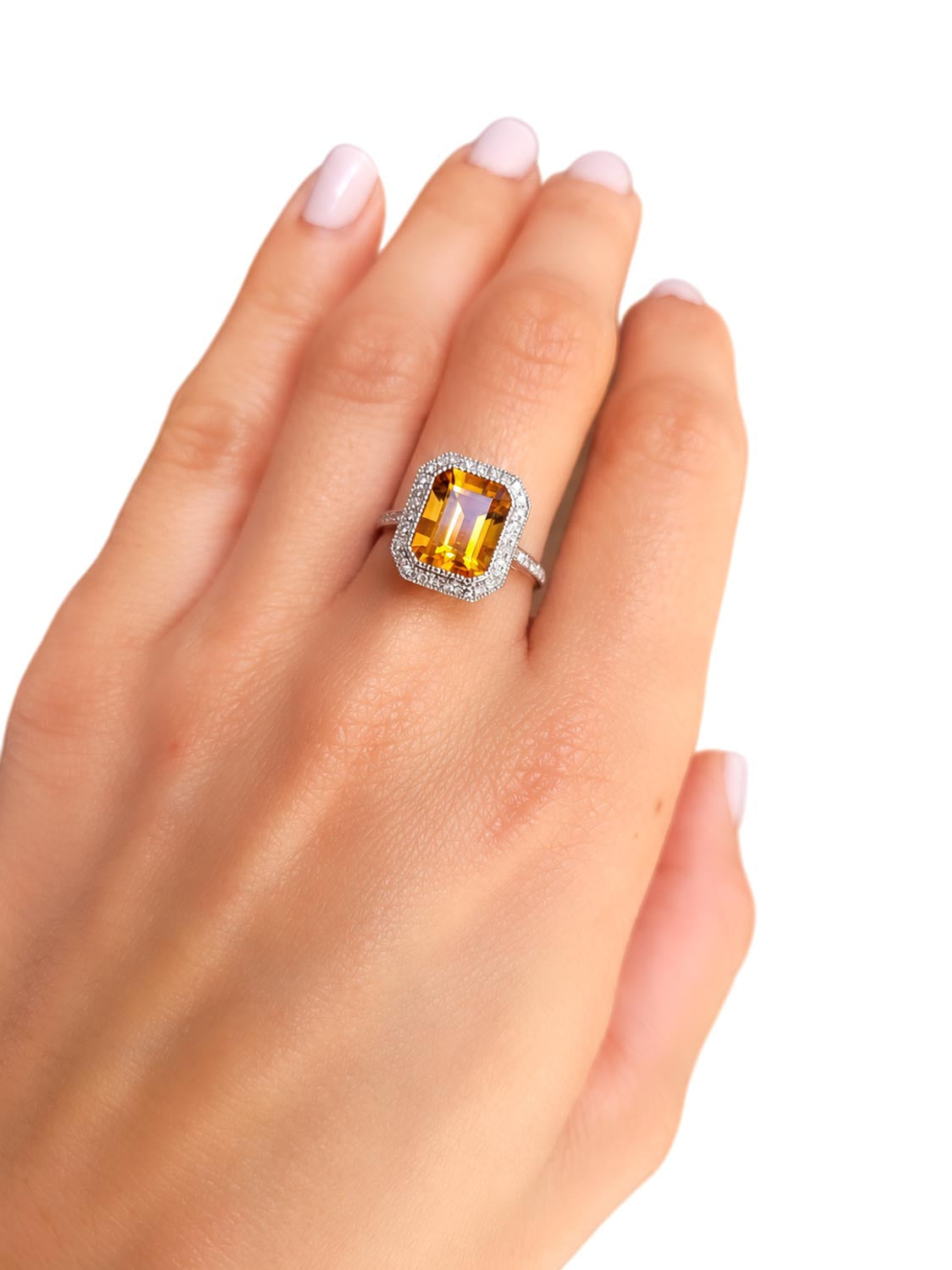 Close detail of the emerald cut citrine and diamond halo