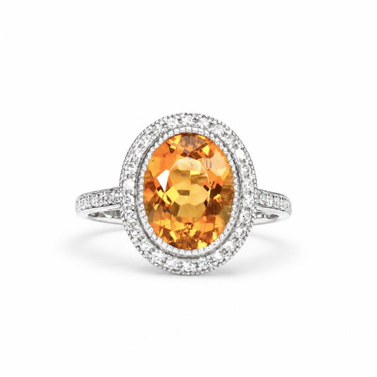 Oval cut citrine ring with a diamond halo in 18K white gold