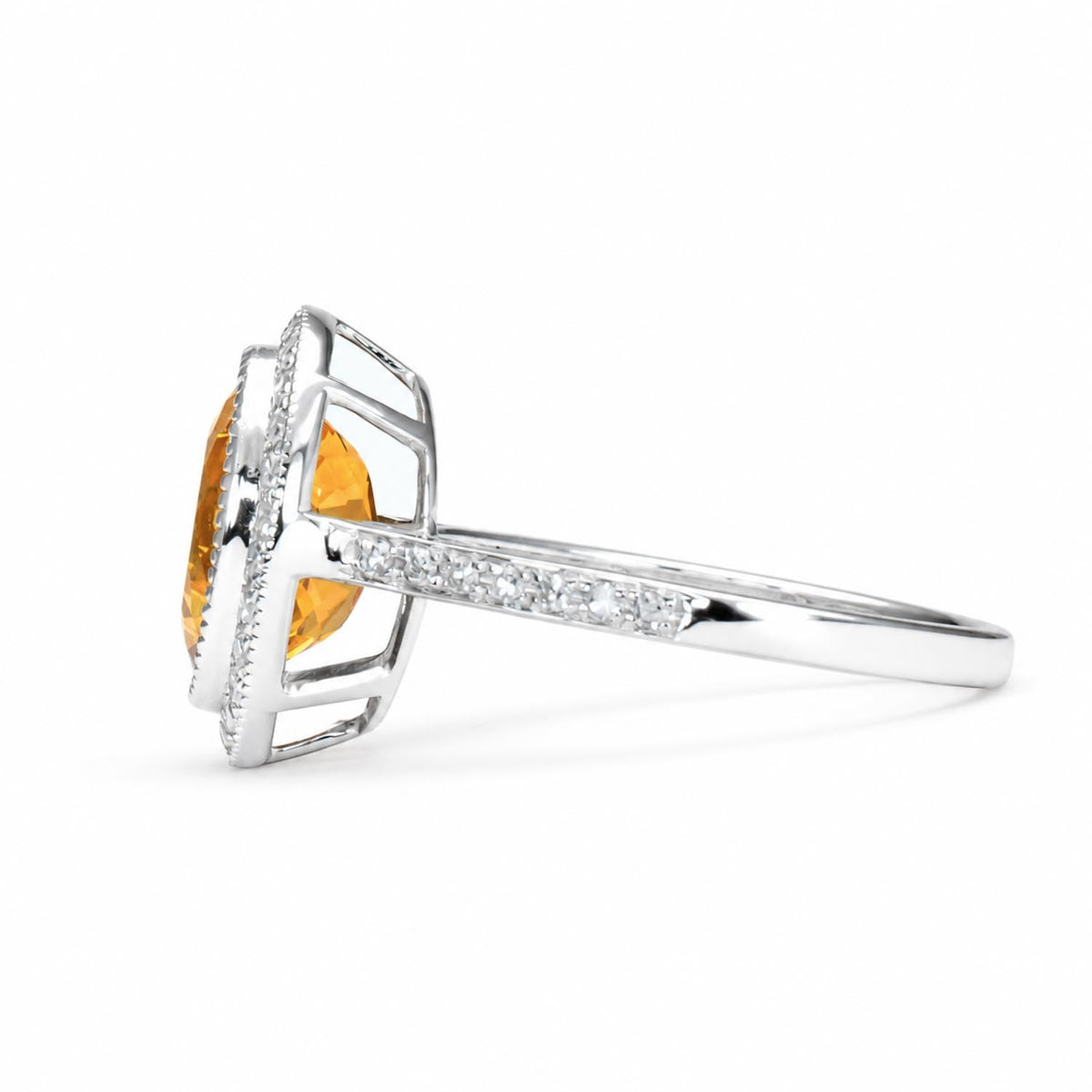 Oval citrine and diamond halo ring in 18K white gold shown at an angle