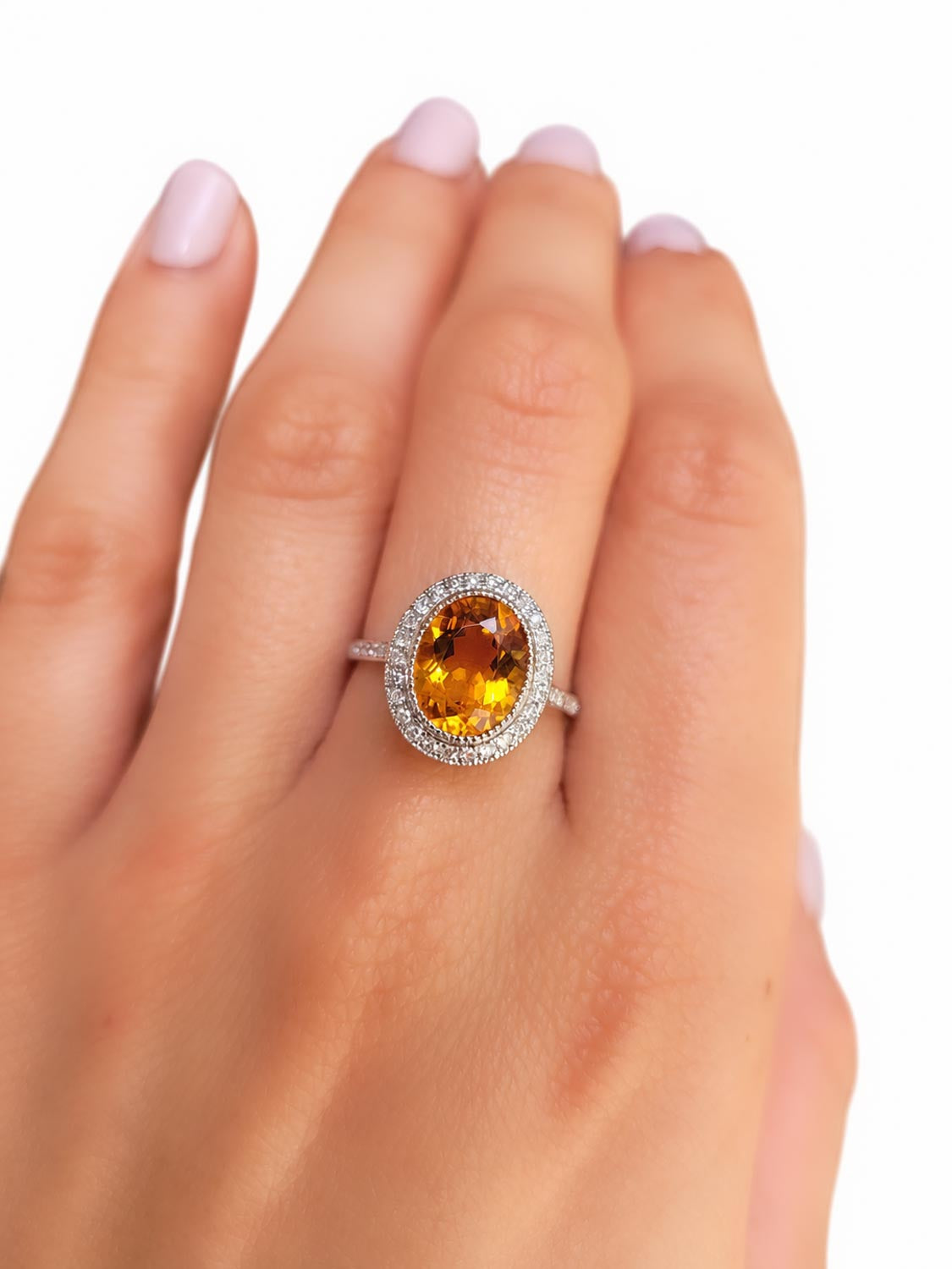 Close detail of the oval citrine and diamond halo
