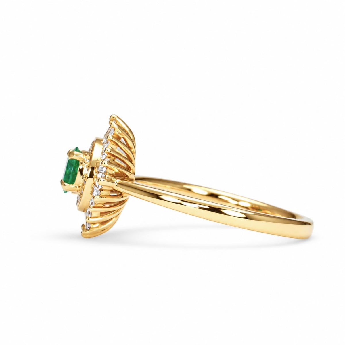 Colombian emerald sunburst halo diamond ring in 18K yellow gold, angled view