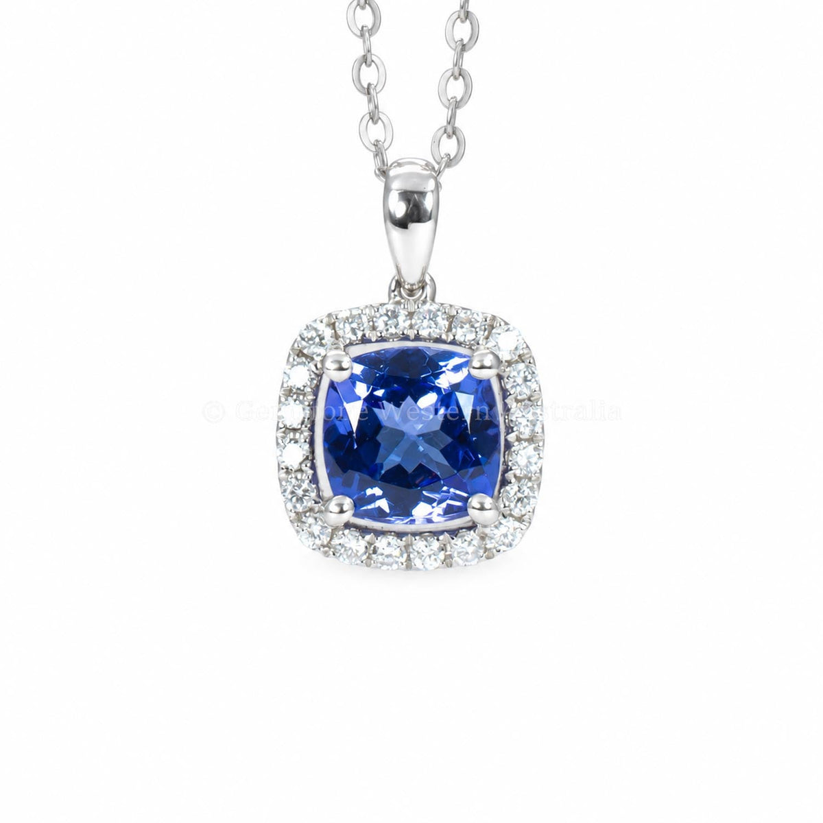 Cushion cut tanzanite pendant with a diamond halo in 18K white gold