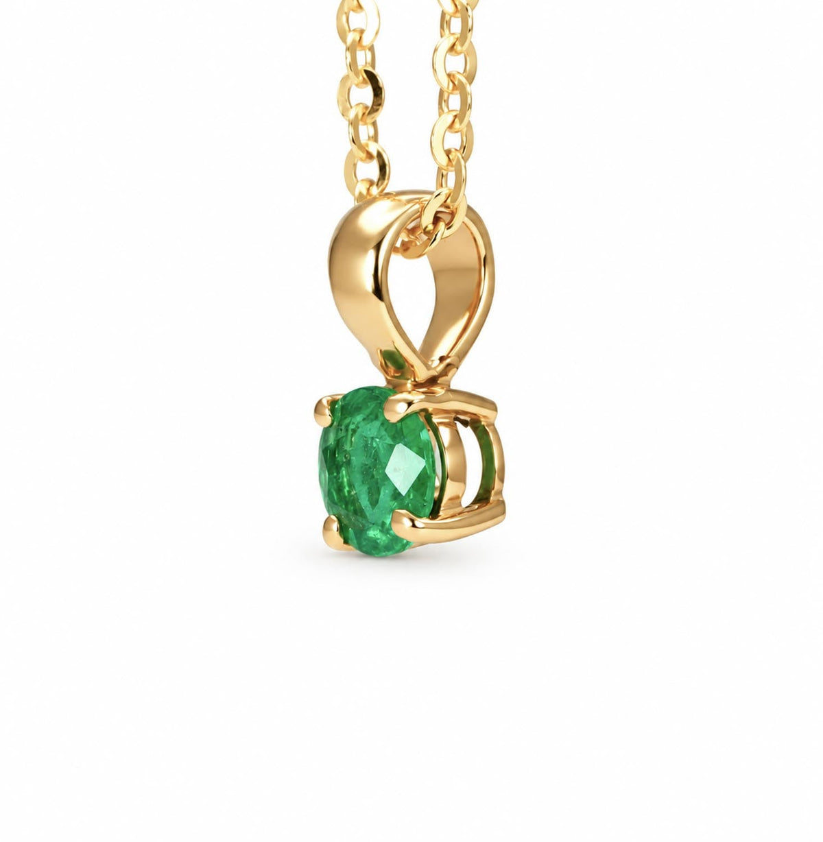 Petite Colombian emerald pendant in 18K yellow gold shown at an angle