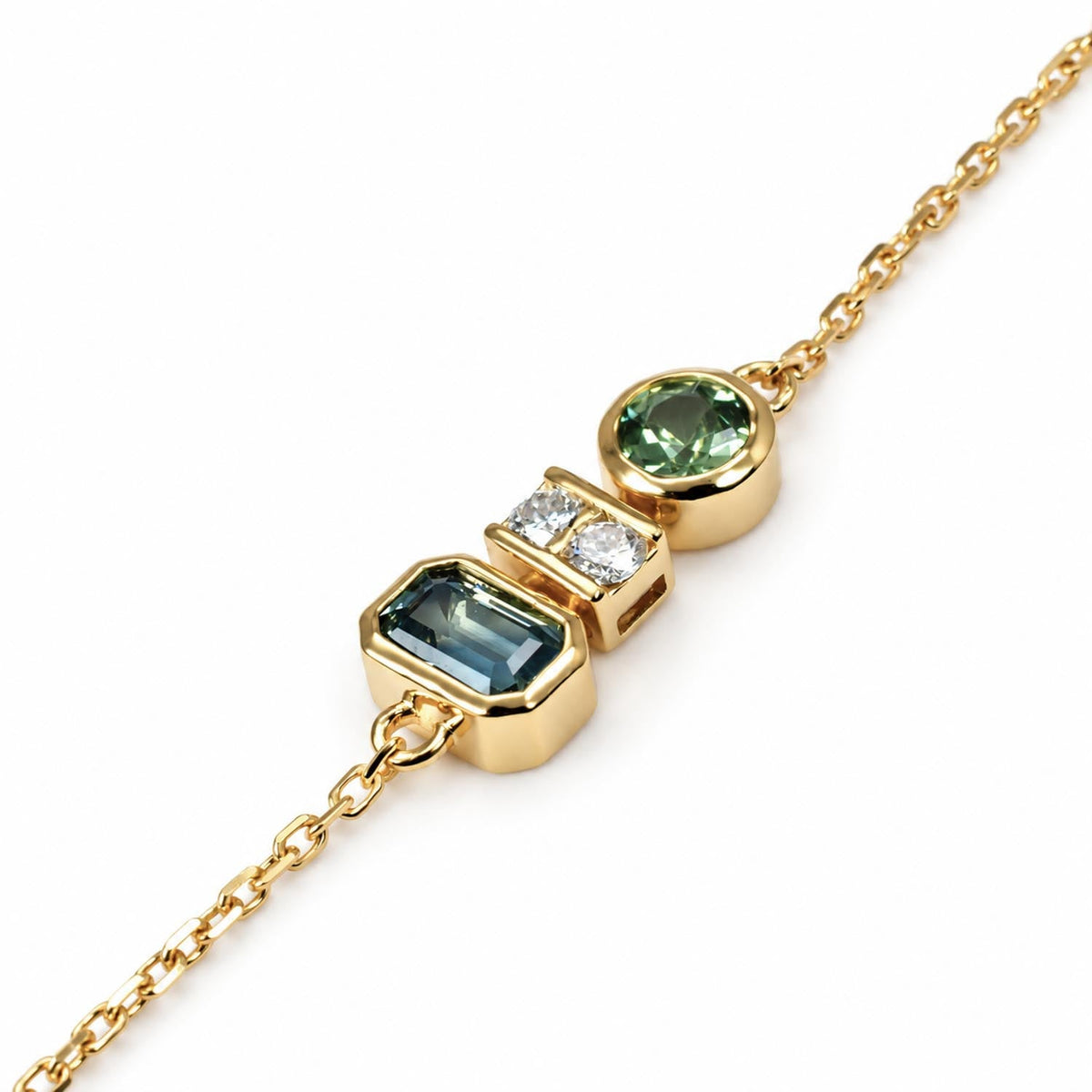 Teal sapphire and diamond bracelet in 18K yellow gold shown at an angle