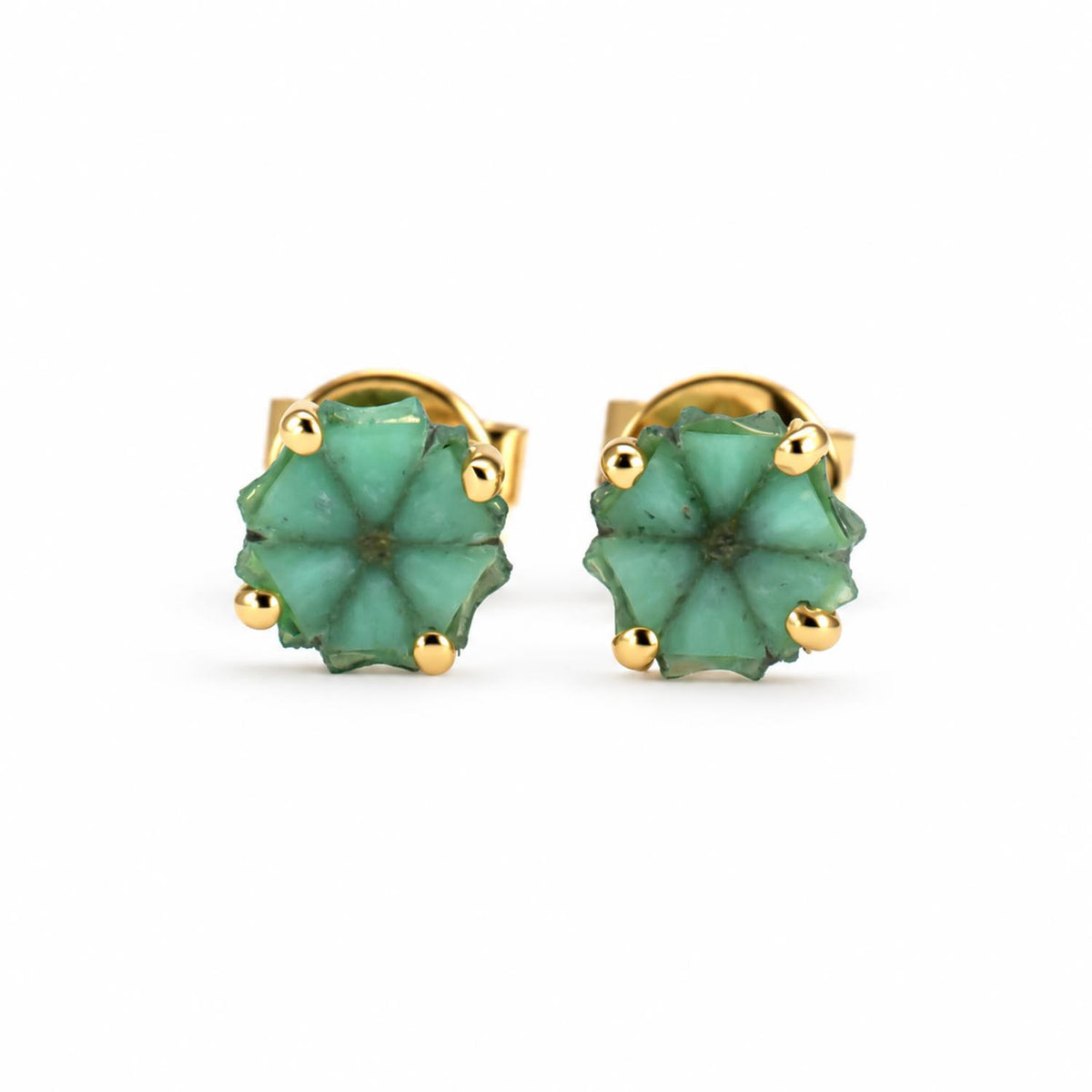 a pair of trapiche emerald earrings set in 18K yellow gold shown on a white background
