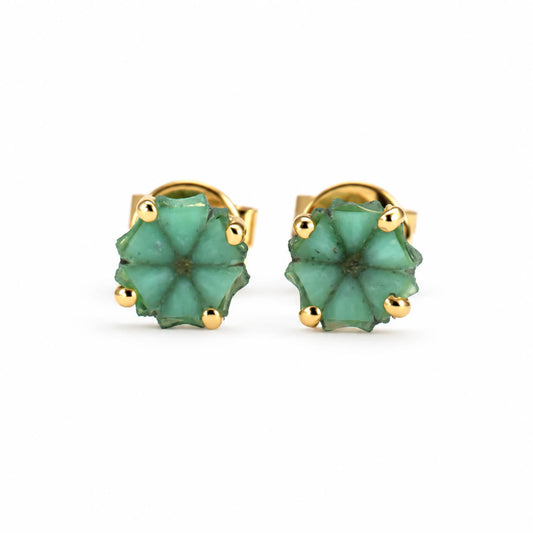 a pair of trapiche emerald earrings set in 18K yellow gold shown on a white background
