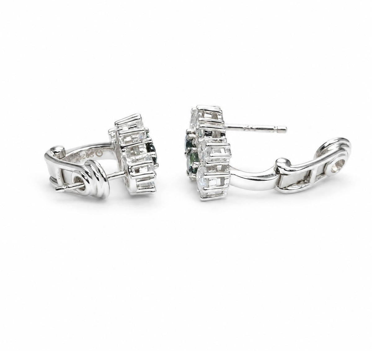 Close detail of the teal sapphire and moissanite cluster in sterling silver