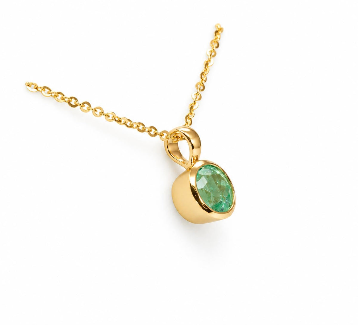 Close detail of the Colombian emerald in its gold bezel setting
