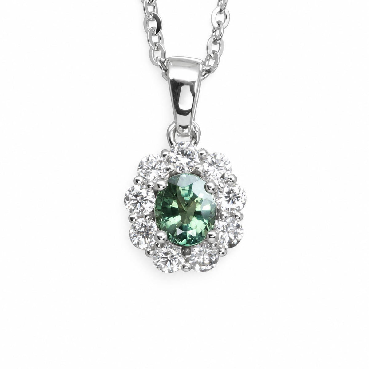 A platinum pendant necklace featuring a central alexandrite gemstone surrounded by a halo of diamonds, suspended from a silver chain on a white background.